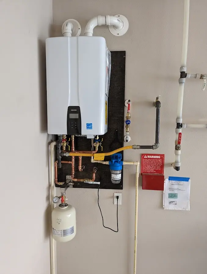 Professional plumber installing copper piping in a Chicago home